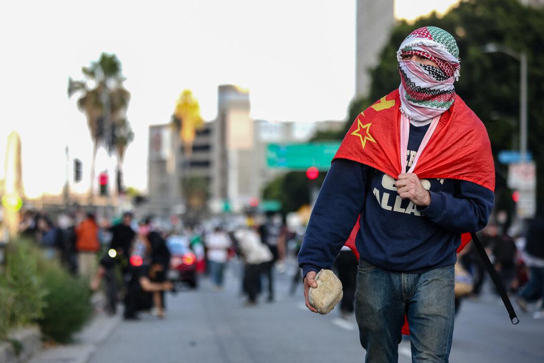 A protester carries a rock in Los Angeles on June 8, 2025. (Jim Vondruska/Getty Images)