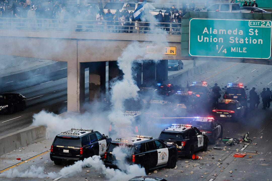 California Highway Patrol cars, some damaged, are lined up along the 101 freeway after officers cleared protesters from the area in Los Angeles on June 8, 2025. (Mario Tama/Getty Images)