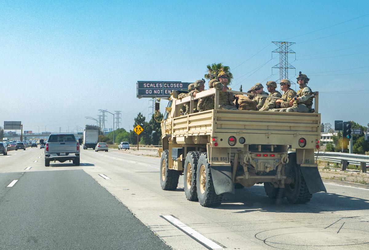 A military unit moves down the 405 Freeway in response to rioting in Los Angeles on June 10, 2025. (John Fredricks/The Epoch Times)