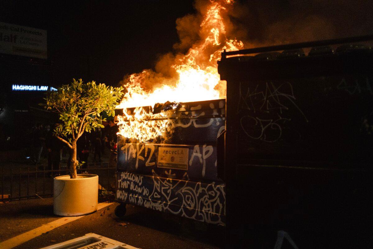 Protesters set a dumpster on fire during clashes with police in downtown Los Angeles on June 8, 2025. (Jim Vondruska/Getty Images)