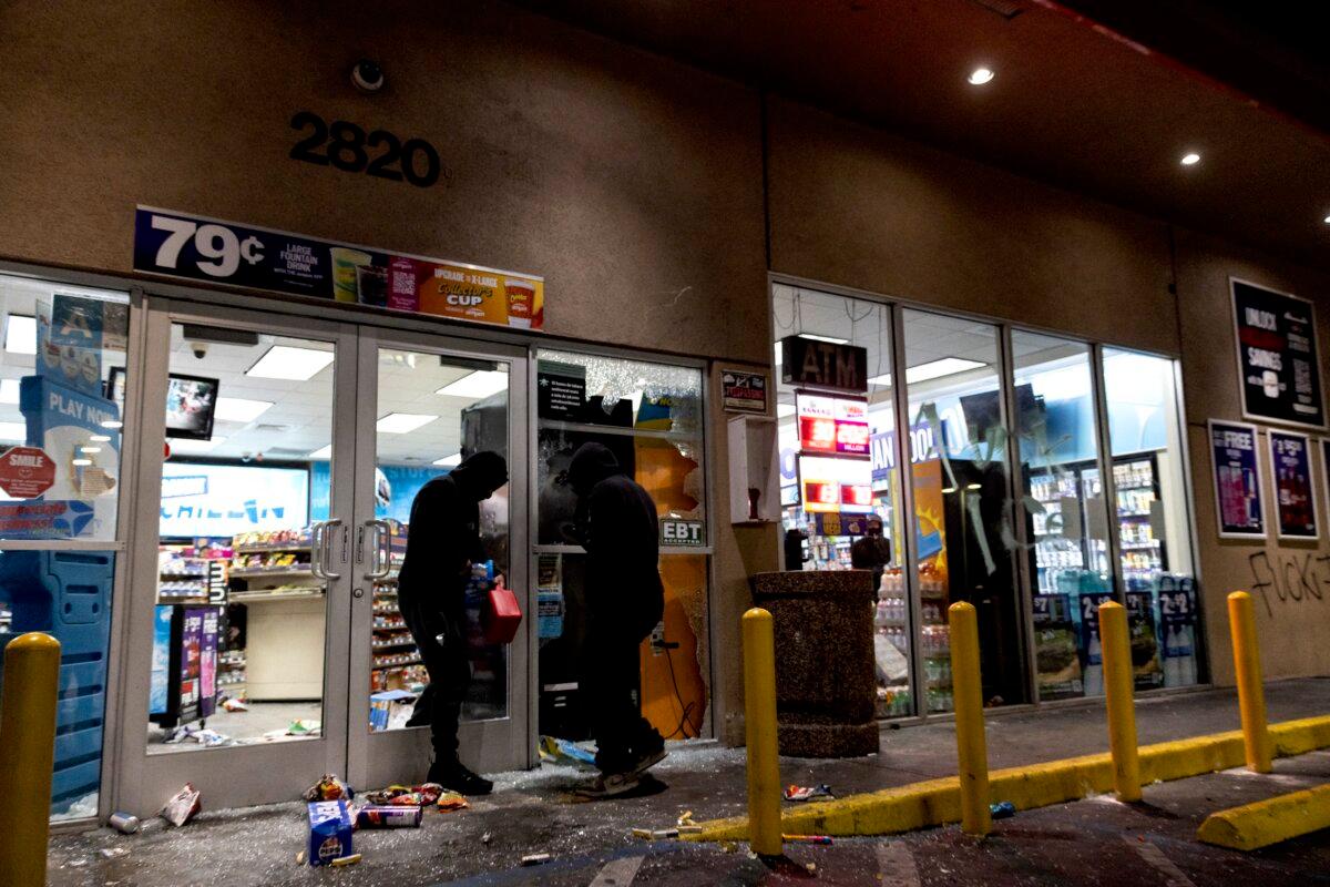 Looters break in to a gas station as demonstrators and law enforcement clash during a protest following federal immigration operations in the Compton neighborhood of Los Angeles on June 8, 2025. (Etienne Laurent/AFP via Getty Images)