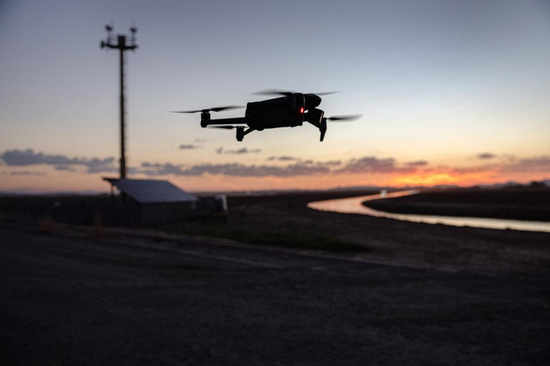 A DJI Mavic 3 drone flies past a U.S. government surveillance tower near the U.S.–Mexico border in Yuma, Ariz., on Sept. 27, 2022. (John Moore/Getty Images)