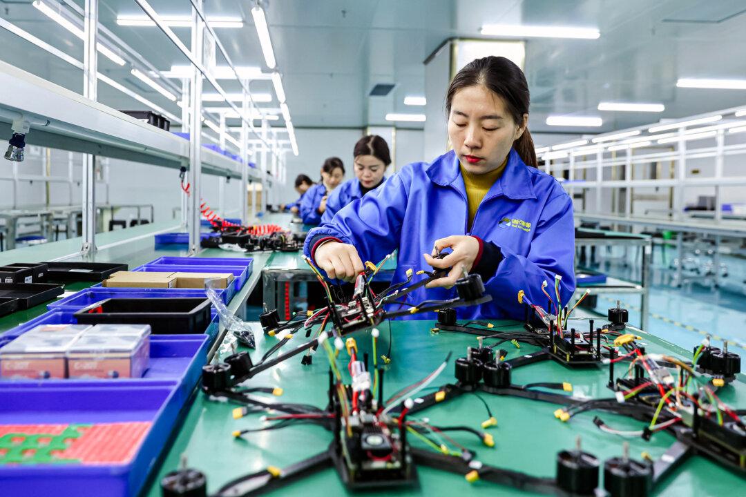 Employees work on a production line of drones intended for export at a factory in Ruichang, Jiangxi Province, China, on Nov. 27, 2024. (STR/AFP via Getty Images)