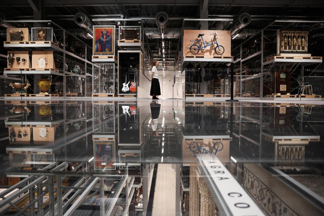 A visitor looks at artifact exhibited in the newly opened V&A East Storehouse museum, in East London, on June 12, 2025. London's Victoria and Albert Museum has launched the revolutionary new exhibition space, where visitors can choose from some 250,000 objects, order something they want to spend time looking at, and have it delivered to a room for a private viewing. (Henry Nicholls/AFP via Getty Images)