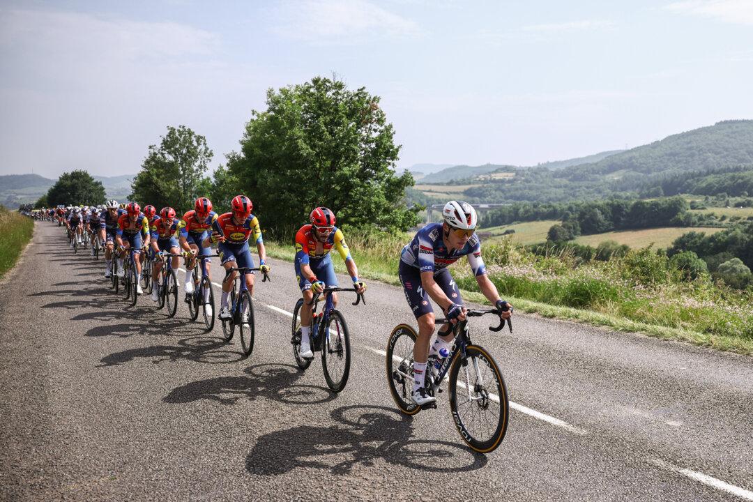 A pack of riders cycle during the 5th stage of the 77th edition of the Criterium du Dauphine cycling race between Saint-Priest and Mâcon, France, on June 12, 2025. (Anne-Christine Poujoulat/AFP via Getty Images)