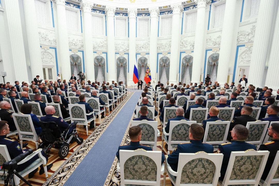 In this pool photograph distributed by the Russian state agency Sputnik, Russia's President Vladimir Putin meets with service members as part of the 'Time of Heroes' program, which aims to integrate veterans into high-ranking public positions, at the Kremlin in Moscow on June 12, 2025. (Sergei Bulkin/Pool/AFP via Getty Images)