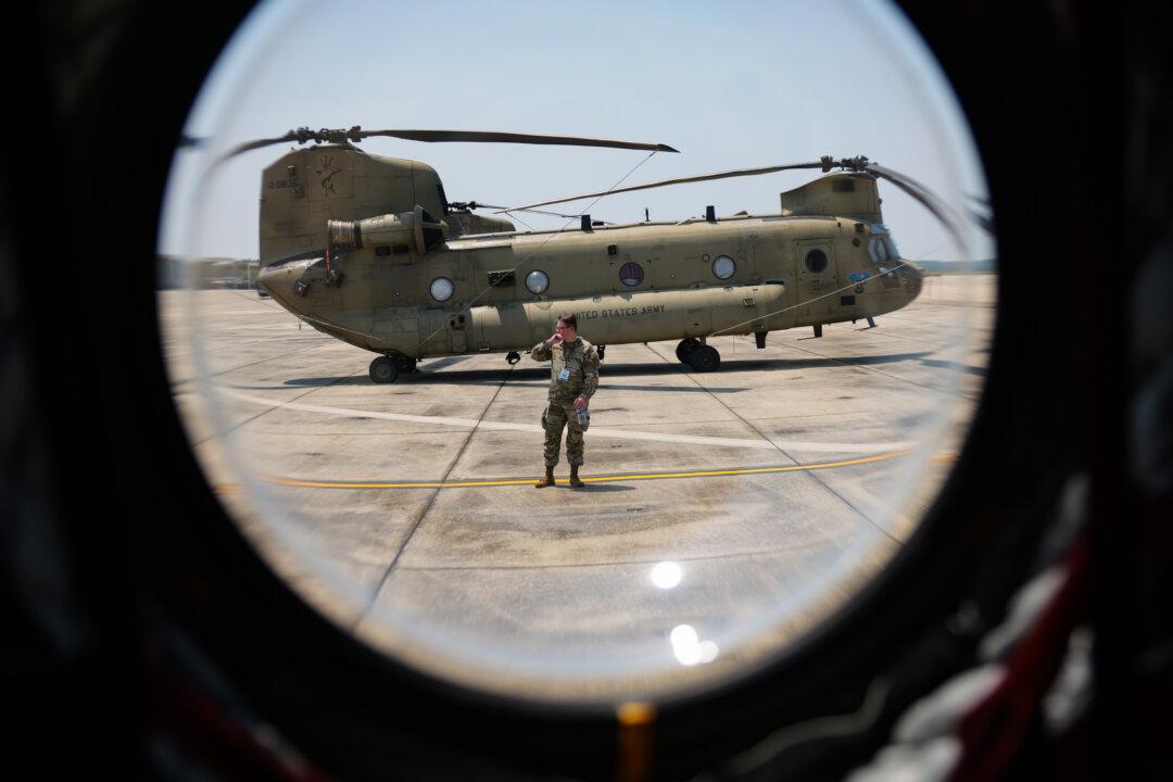 A U.S. Army CH-47 Chinook helicopter sits on the flight line at Joint Base Andrews, Md., on June 12, 2025. Army helicopters, including Black Hawks, Apaches, Chinooks, and other military aircraft, will be used in the upcoming U.S. Army's 250th birthday parade. (Kayla Bartkowski/Getty Images)