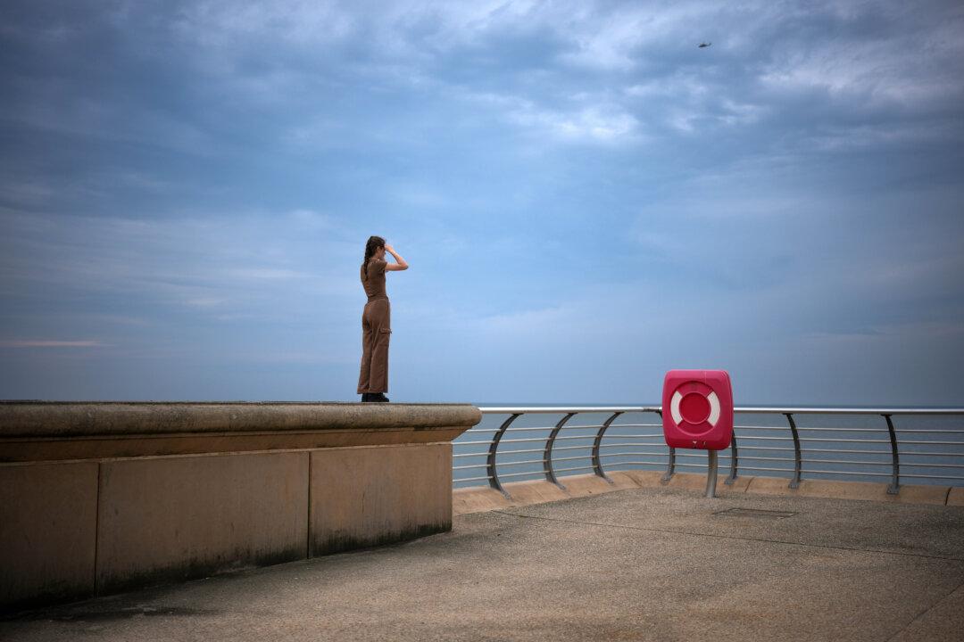A girl stands on the seawall and looks out to sea from Blackpool Promenade in Blackpool, England, on June 12, 2025. (Christopher Furlong/Getty Images)