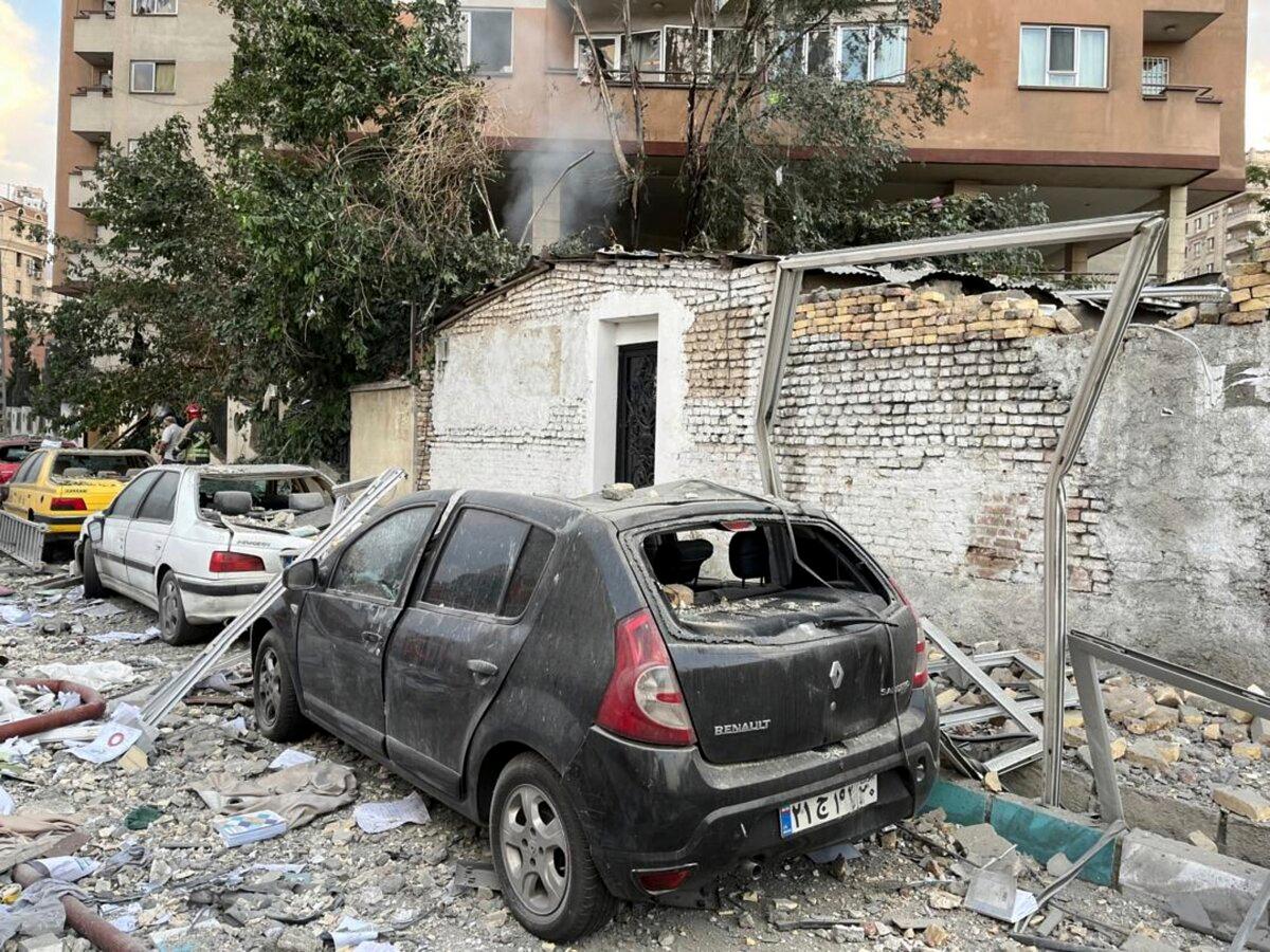 Debris from an apartment building is seen on top of parked cars after a strike in Tehran, Iran, early Friday, June 13, 2025. (AP Photo/Vahid Salemi)