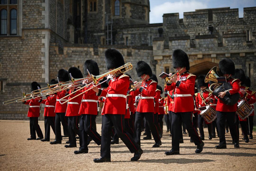 The Band of The Coldstream Guards enters the Quadrangle during a ceremony to present new Colours to the 1st and 2nd Battalion at Windsor Castle in Windsor, England, on June 13, 2025. (Henry Nicholls - WPA Pool/Getty Images)