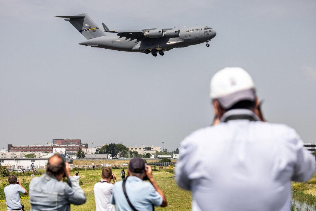 People take pictures of a Boeing C-17 Globemaster III transport plane, landing at Schiphol Airport near Amsterdam on June 13, 2025. (Jeffrey Groeneweg/ANP/AFP via Getty Images)