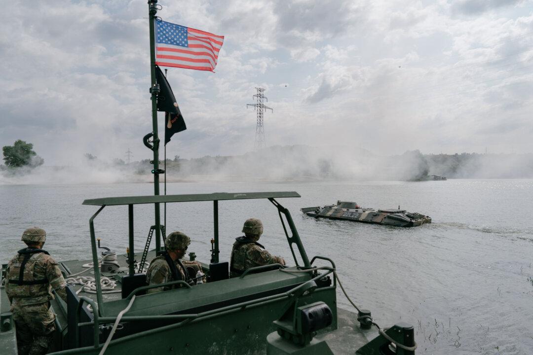 U.S. and Romanian soldiers take part in a military exercise in Frecatei, Romania, on June 13, 2025. Over 700 personnel from Italy, Romania, and the United States are participating in military exercises on the Danube River, followed by further exercises on the Siret River. The scenario they are role playing involves hundreds of pieces of technical equipment as they force a watercourse onto one of the branches of the Danube. (Andrei Pungovschi/Getty Images)