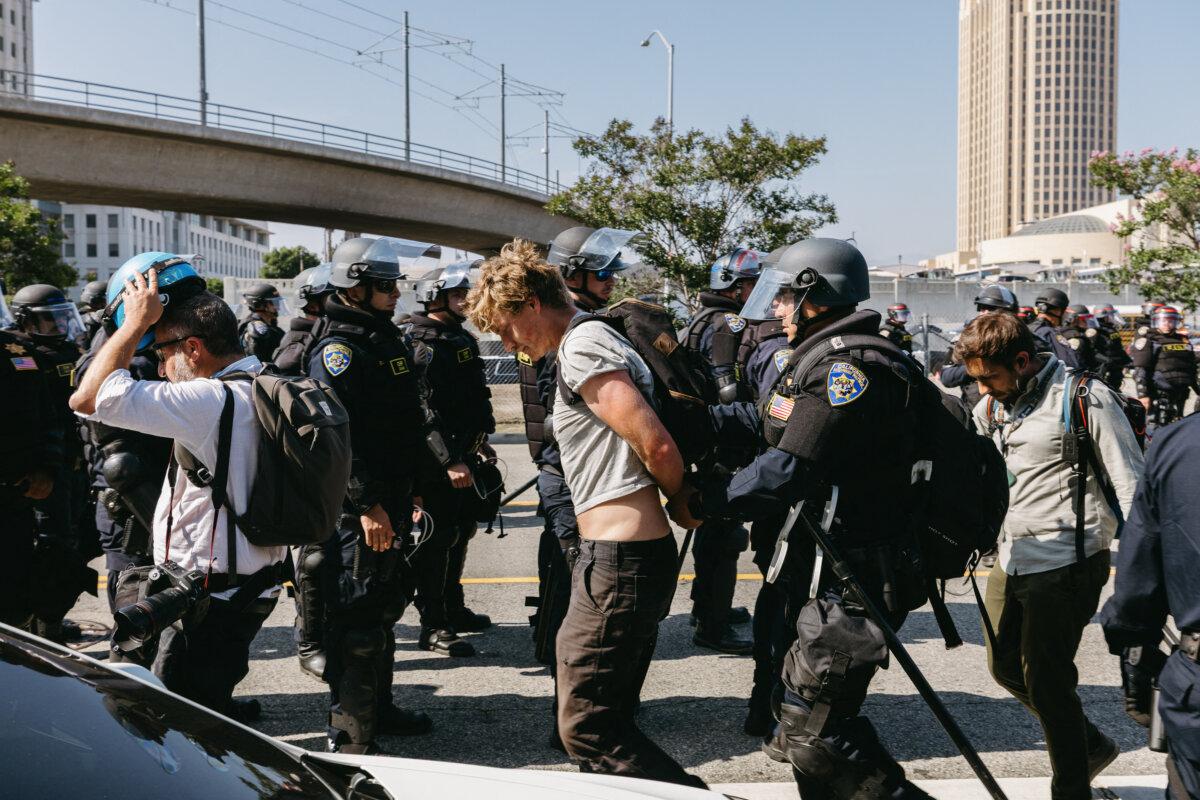 California Highway Patrol officers arrest an unidentified demonstrator during protests in Los Angeles on June 10, 2025. (David Pashaee/Middle East Images/AFP via Getty Images)