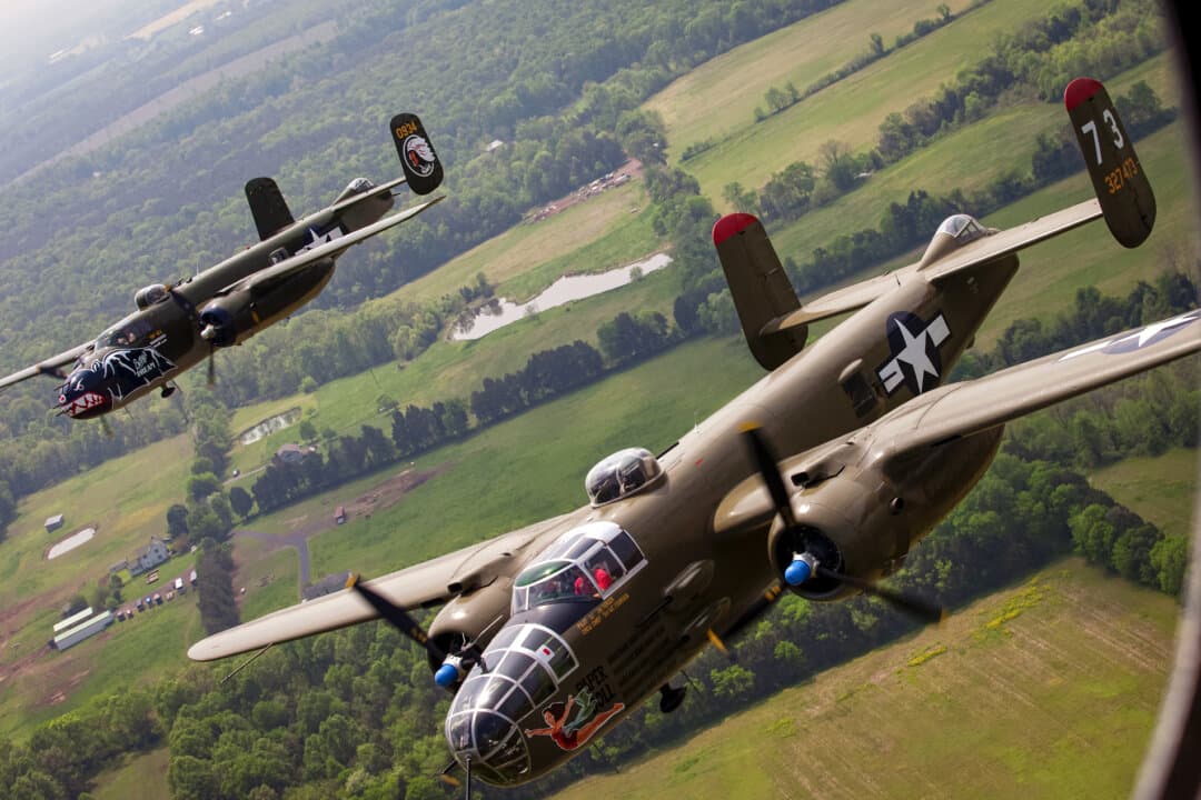 Two B-25 Mitchell bombers fly in formation with dozens of other World War II-era aircraft over Culpeper Regional Airport in Brandy Station, Va., on May 7, 2015. (Andrew Caballero-Reynolds/AFP via Getty Images)