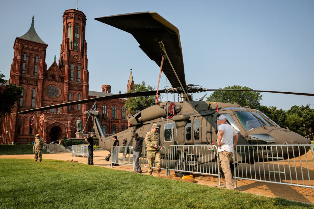 Barricades surround a U.S. Army Sikorsky UH-60 Black Hawk helicopter on display on the National Mall for weekend events marking the Army’s 250th anniversary near the Smithsonian Castle in Washington on June 11, 2025. (Chip Somodevilla/Getty Images)