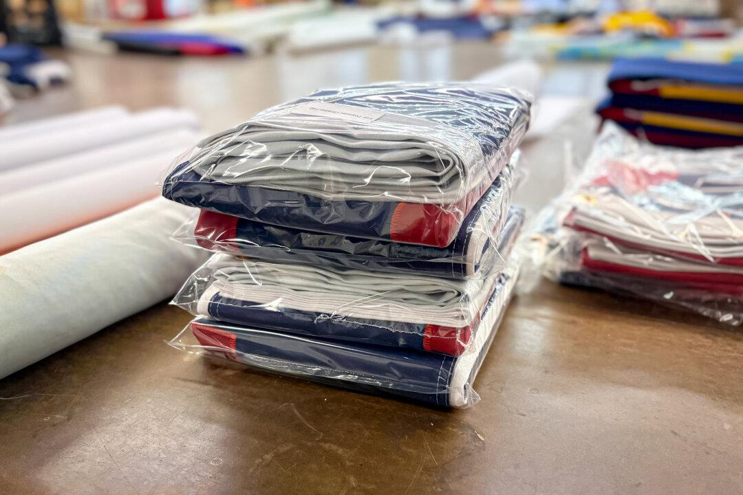 (Top) Artie Schaller III, president of National Flag Company, and his mother, Cindy Schaller, at the National Flag Company in Cincinnati on June 6, 2025. The Schallers have been making flags since 1903. (Bottom Left) American flags come together at the National Flag Company in Cincinnati on June 6, 2025. (Bottom Right) Flags at the National Flag Company in Cincinnati on June 6, 2025. (Nathan Worcester/The Epoch Times)