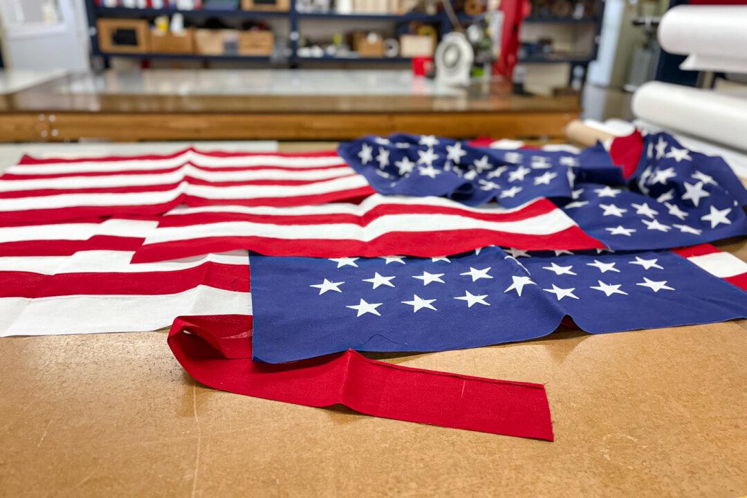 (Top) Artie Schaller III, president of National Flag Company, and his mother, Cindy Schaller, at the National Flag Company in Cincinnati on June 6, 2025. The Schallers have been making flags since 1903. (Bottom Left) American flags come together at the National Flag Company in Cincinnati on June 6, 2025. (Bottom Right) Flags at the National Flag Company in Cincinnati on June 6, 2025. (Nathan Worcester/The Epoch Times)