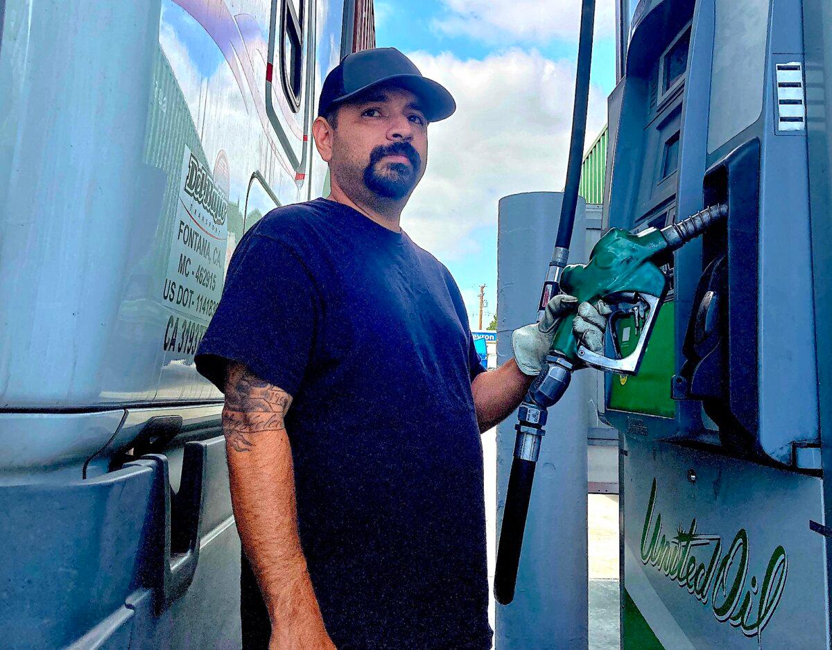 Commercial truck driver Phillip Guirre of Fontana, Calif., prepares to fill his company's semi with diesel in Long Beach, Calif., on June 5, 2025. (Allan Stein/The Epoch Times)