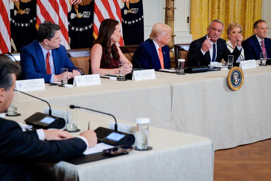 (L–R) White House domestic policy director Vince Haley, Agriculture Secretary Brooke Rollins, President Donald Trump, Health Secretary Robert F. Kennedy Jr., Education Secretary Linda McMahon, and Environmental Protection Agency Administrator Lee Zeldin attend an event at the White House on May 22, 2025. A new Make America Healthy Again Commission report targets processed food and chemical toxins as key contributors to chronic disease and declining health among U.S. children. (Chip Somodevilla/Getty Images)