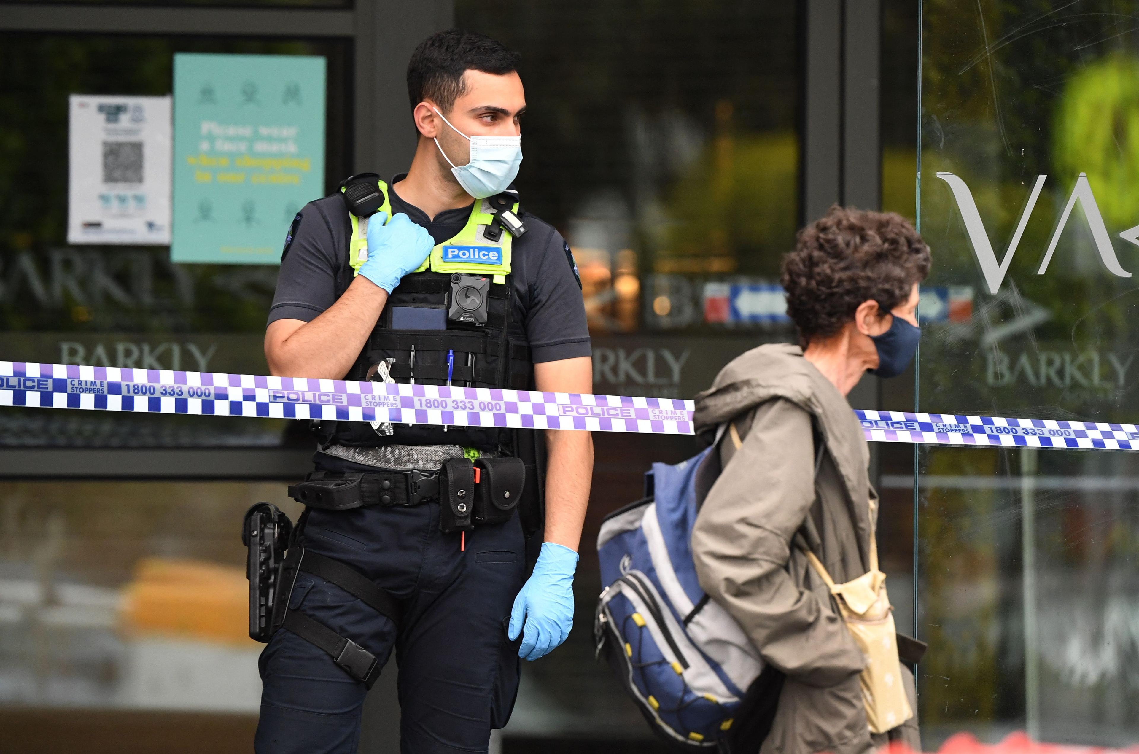 A policeman stands guard outside a shopping centre in Melbourne, Australia on Oct. 18, 2021. (William West/AFP via Getty Images)