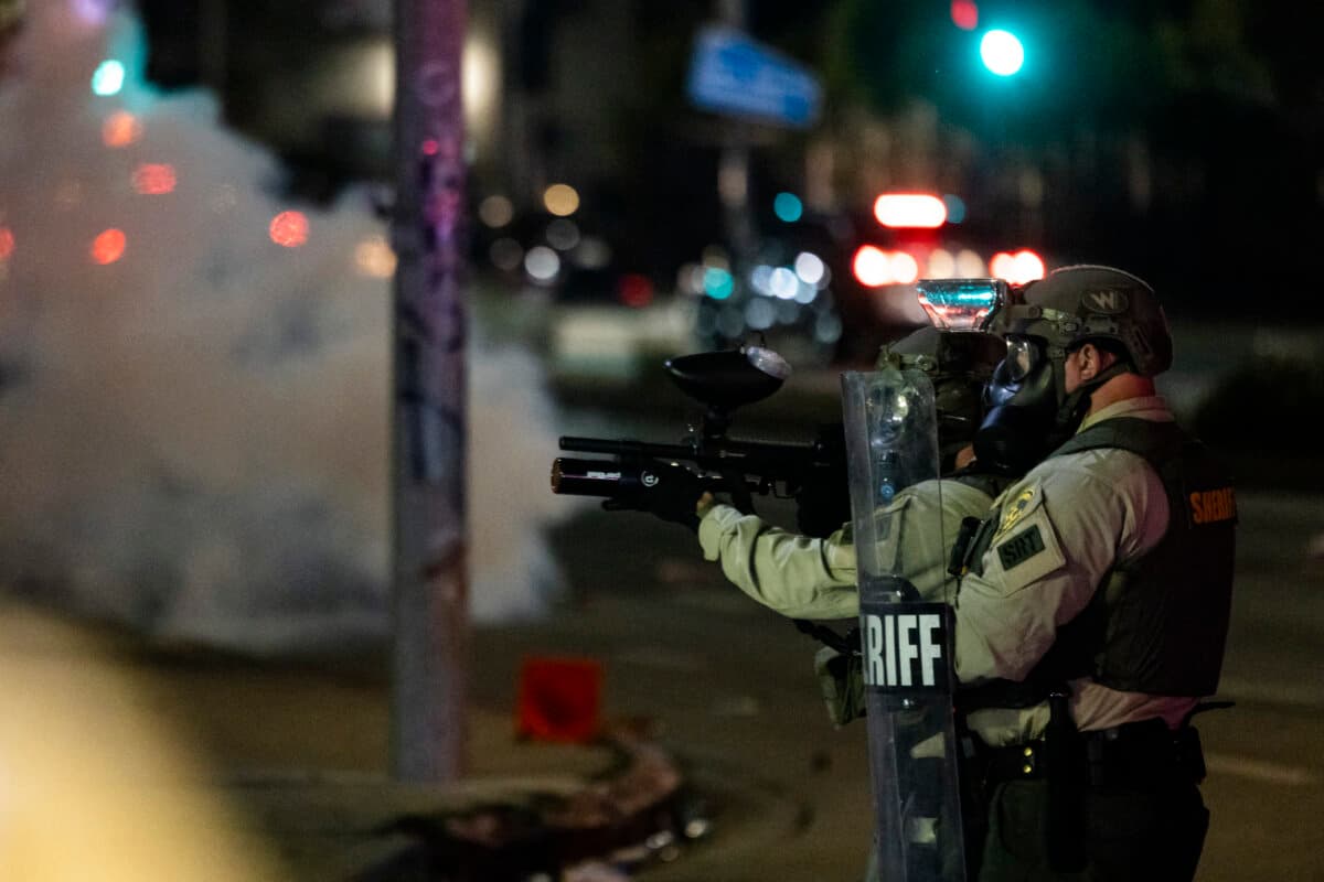 Law enforcement and demonstrators clash during a protest following federal immigration operations, in the Compton neighborhood of Los Angeles early on June 8, 2025. (Etienne Laurent / AFP)