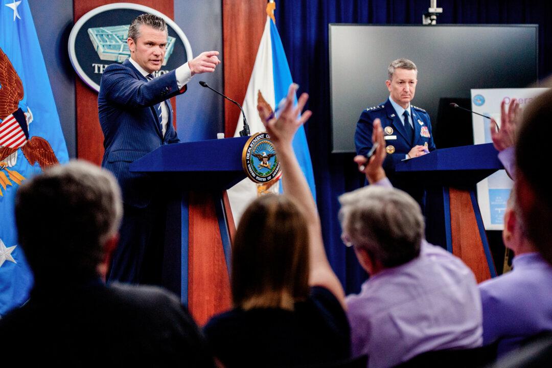 Defense Secretary Pete Hegseth (L), accompanied by Chairman of the Joint Chiefs of Staff Gen. Dan Caine, takes a question from a reporter during a news conference at the Pentagon in Arlington, Va., on June 22, 2025. President Donald Trump gave an address to the nation on June 21 after three Iranian nuclear facilities were struck by the U.S. military. (Andrew Harnik/Getty Images)