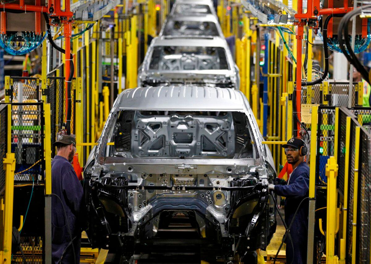 Workers assemble cars at the newly renovated Ford Assembly Plant in Chicago on June 24, 2019. (Jim Young/ AFP via Getty Images)
