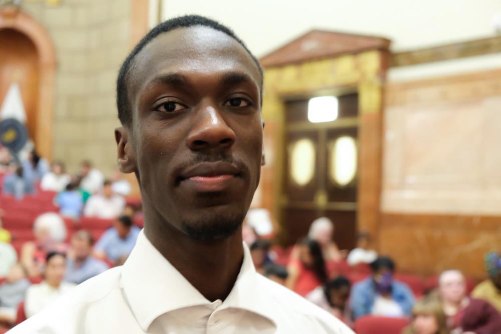 Benjamin Ndori, 18, appears at a naturalization ceremony at the War Memorial in Indianapolis on June 26, 2025. (Lawrence Wilson/The Epoch Times)