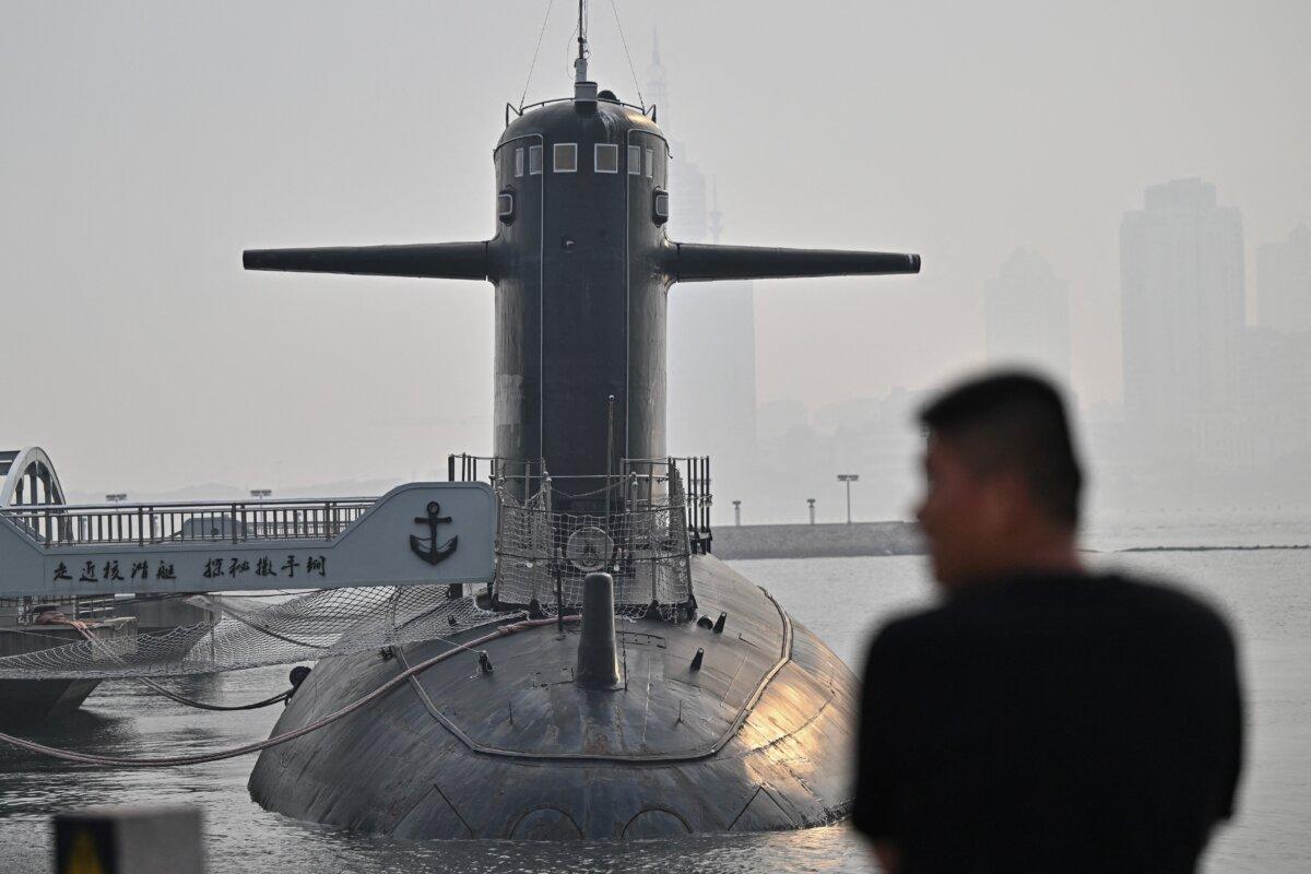 A man looks at a submarine during a media tour by the PLA Naval Museum in Shandong Province, China, on June 25, 2025. (Pedro Pardo/AFP via Getty Images)