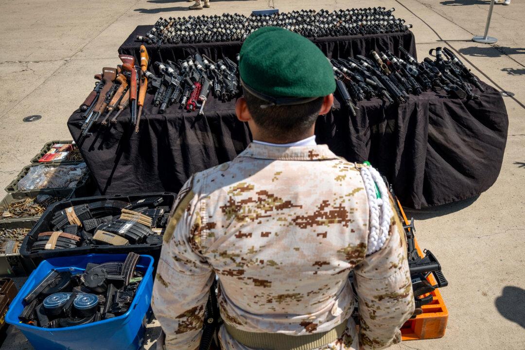 A soldier stands before a display of guns seized by the Mexican Army, National Guard, and State Police ahead of their destruction at the 2nd Military Zone headquarters in Tijuana, Mexico, on Aug. 8, 2024. The U.S. Supreme Court ruled on June 5 that American gunmakers cannot be sued by the Mexican government over cartel-related violence. (Guillermo Arias/AFP via Getty Images)