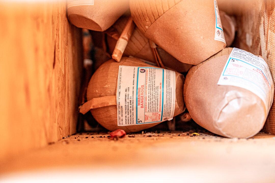 (Top) A sign at Rozzi’s Famous Fireworks in Martinsville, Ohio, on June 26, 2025. (Bottom) Fireworks shells in a storage area at Rozzi’s Famous Fireworks show-preparation site in Martinsville, Ohio, on June 26, 2025. (Samira Bouaou/The Epoch Times)