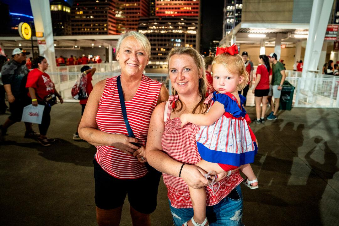 Jenny Butler (L) poses with her daughter, Emily Cooper, and granddaughter Elsie, after the little girl watched her first fireworks show, produced by Rozzi’s Famous Fireworks, at Great American Ball Park in Cincinnati on June 27, 2025. (Samira Bouaou/The Epoch Times)