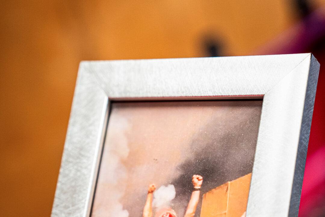 Joe Rozzi, 57, holds a photo of himself celebrating after a fireworks show at the Rozzi’s Famous Fireworks’ office in Martinsville, Ohio, on June 26, 2025. (Samira Bouaou/The Epoch Times)