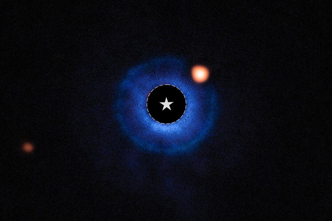 Astronomers using NASA’s James Webb Space Telescope have captured compelling evidence of a planet with a mass similar to Saturn orbiting the young nearby star TWA 7. In this image combining ground-based data from ESO’s Very Large Telescope (VLT) and data from Webb’s MIRI (Mid-Infrared Instrument), light from the star TWA 7 has been subtracted. The location of the star is marked with a circle and a star symbol at the center of the image. The blue color represents data from the VLT’s SPHERE instrument, which showcases the location of the disk surrounding the host star. MIRI data is shown in orange. The bright orange spot to the upper right of the star is the source identified as TWA 7 b, within the debris disk. The more distant orange spot visible in the left of the image is an unrelated background star. (NASA, ESA, CSA, Anne-Marie Lagrange (CNRS, UGA), Mahdi Zamani (ESA/Webb))