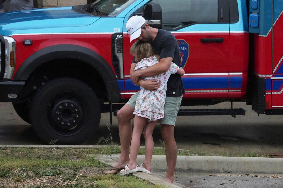 People are reunited at a reunification center after flash flooding hit the area, in Ingram, Texas, on July 4, 2025. (Eric Gay/AP Photo)
