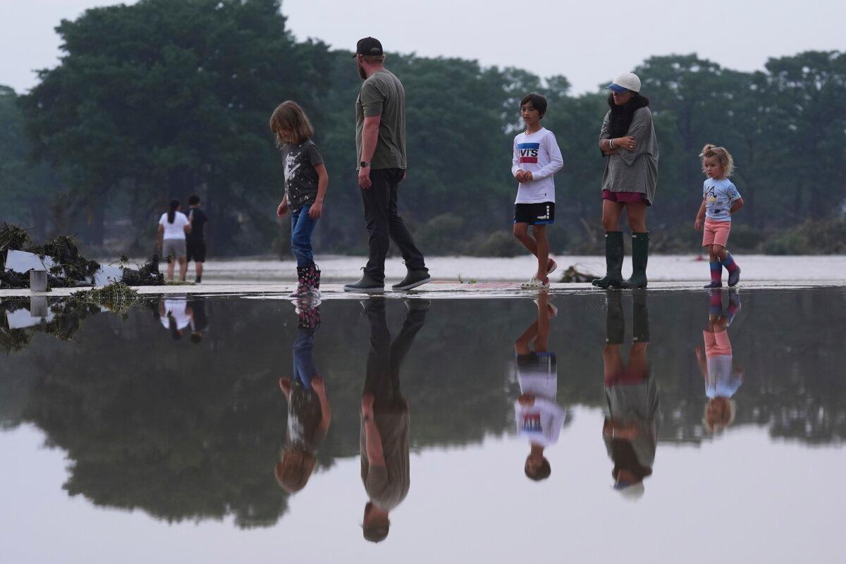 Onlookers survey damage along the Guadalupe River after a flash flood swept through the area, in Kerrville, Texas, on July 4, 2025. (Eric Gay/AP Photo)