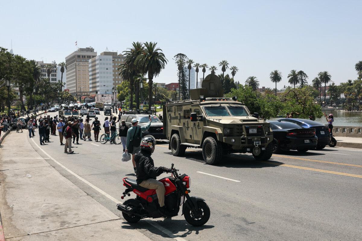 Federal agents ride in multiple armored vehicles down Wilshire Boulevard near MacArthur Park in Los Angeles on July 7, 2025. (Patrick T. Fallon/AFP via Getty Images)