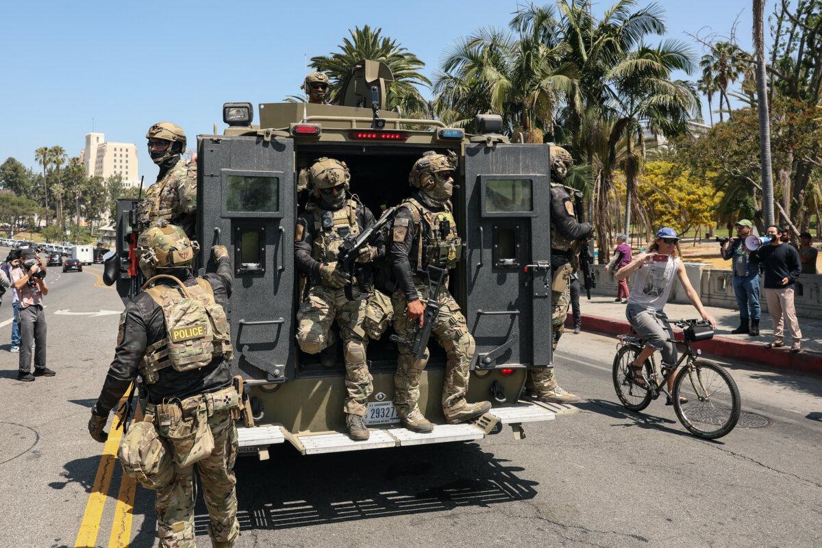U.S. Customs and Border Protection agents ride an armored vehicle down Wilshire Boulevard near MacArthur Park in Los Angeles on July 7, 2025. (Patrick T. Fallon/AFP via Getty Images)