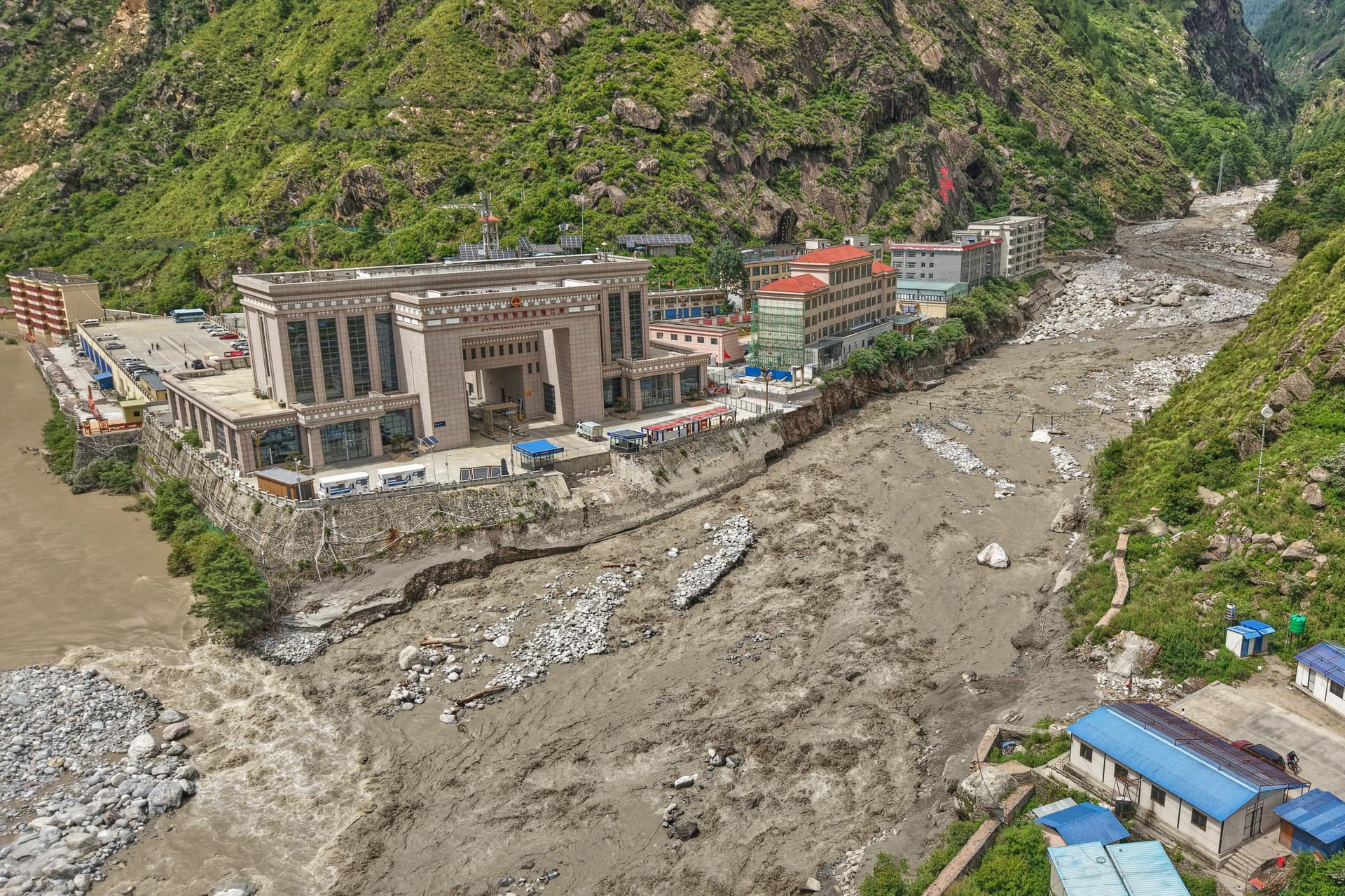 Chinese land on the left and Nepalese land on right after Friendship bridge, a key bridge over the Bhotekoshi River connecting Nepal with China, was swept away in monsoon rain at Rasuwagadi, 120 kilometers (75 miles) north of the capital, Kathmandu, Nepal, on July, 9, 2025. (AP Photo/Sujan Gurung)