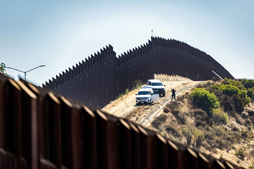 Border Patrol agents monitor the U.S. border wall in San Ysidro, Calif., on July 25, 2024. The new legislation allocates $150 billion for border security and immigration enforcement. (John Fredricks/The Epoch Times)