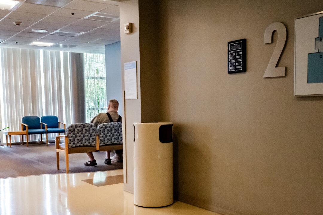 A man waits in a hospital in Irvine, Calif., on July 8, 2025. The One Big Beautiful Bill Act includes changes that could remove millions from Medicaid and impact rural hospitals. (John Fredricks/The Epoch Times)