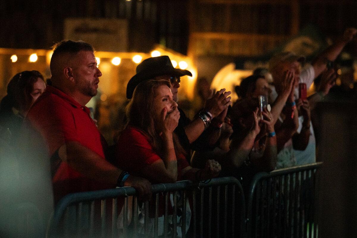 Helen Comperatore looks at her daughters, Kaylee and Allyson, as they speak during a song by Gary Burk III in honor of Corey Comperatore in Russellton, Pa., on July 12, 2025. (Samira Bouaou/The Epoch Times)