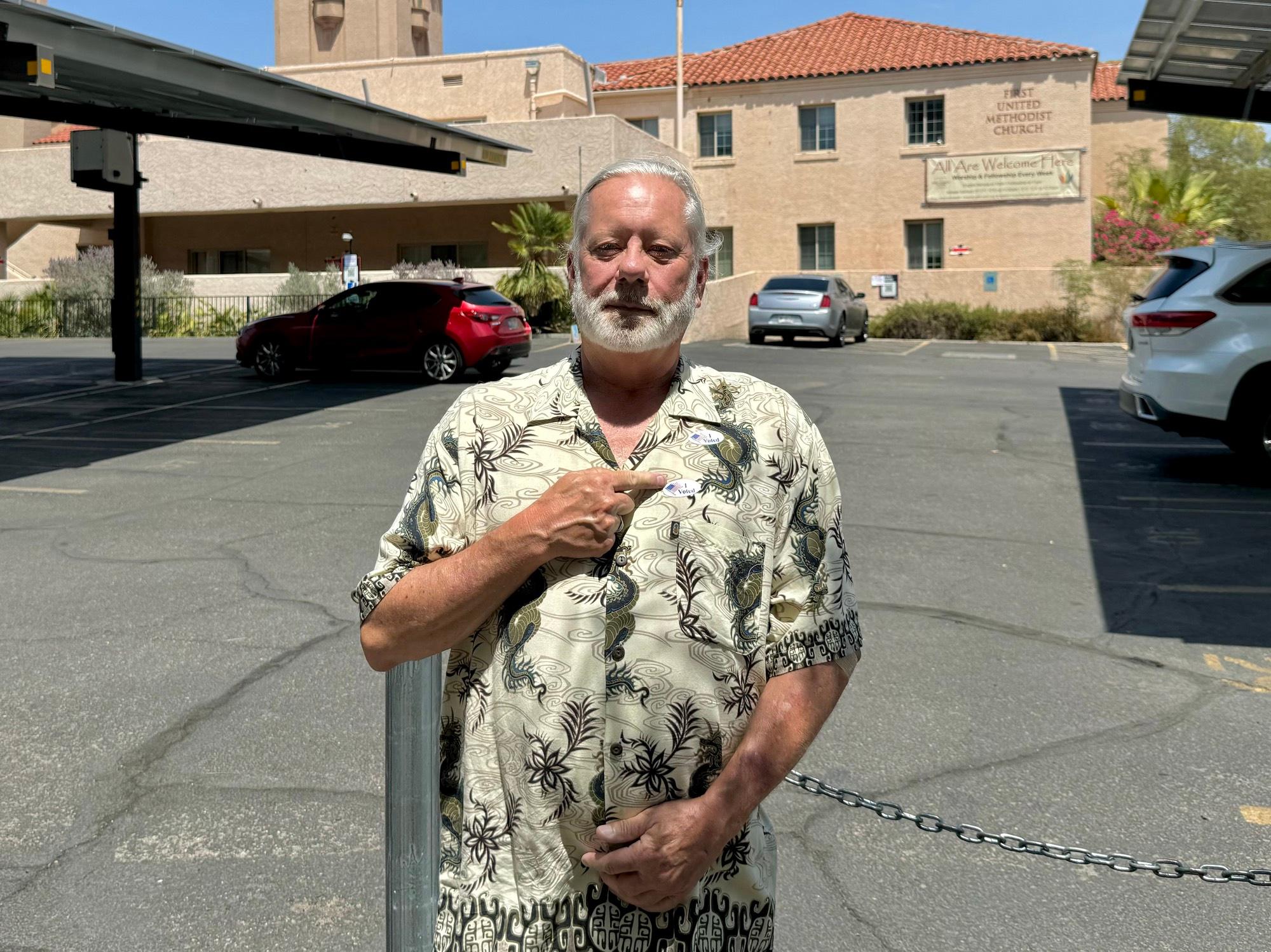Kelly Smith, a voter in Tucson, Ariz., displays his 'I Voted' sticker after casting his ballot at the First Methodist United Church on July 15, 2025. (Arjun Singh/The Epoch Times)