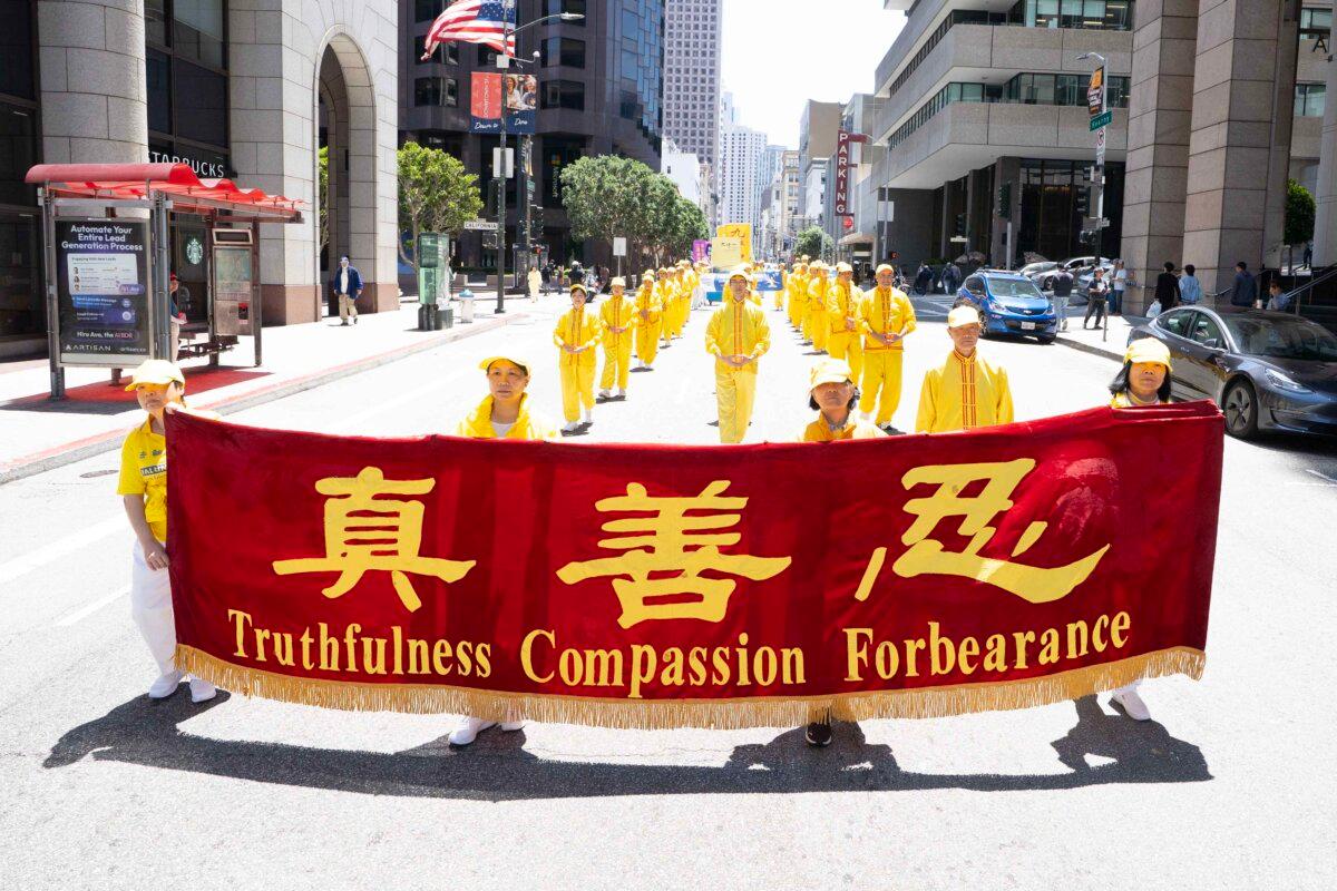 Falun Gong practitioners march in a parade in San Francisco on July 12, 2025. (Gary Wang/The Epoch Times)