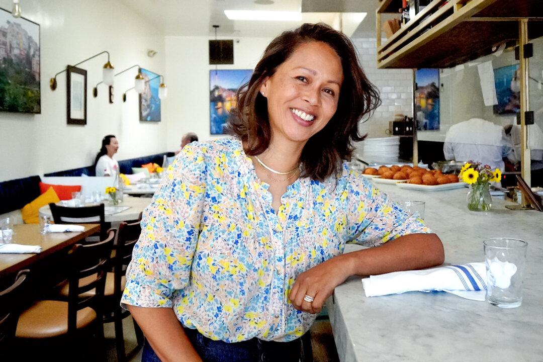 Marlo Vinzino, who lost her restaurant in the Palisades Village, stands at the counter of the new location in Venice, Calif., on July 5, 2025. The Vinzonis lost more than almost all their belongings—six of their regular customers lost their lives in the fire. (Allan Stein/The Epoch Times)