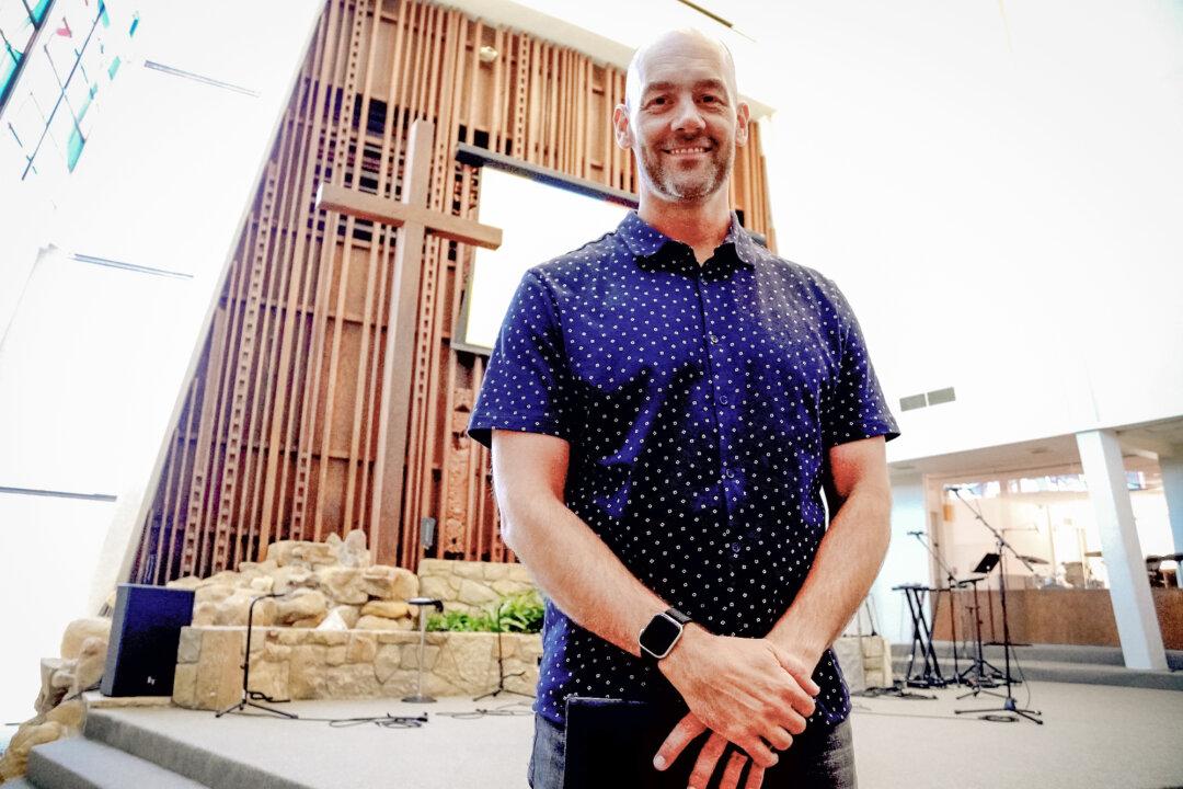 Justin Anderson, lead pastor of the Calvary Church of Pacific Palisades, stands near the altar of the Evans Chapel of the Bel Air Church in Los Angeles on July 6, 2025. The fire broke out on Anderson's very first day on the job. (Allan Stein/The Epoch Times)