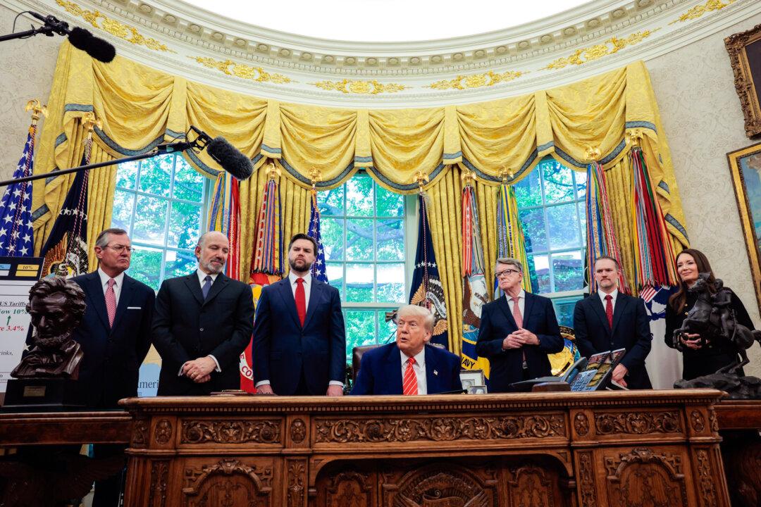 President Donald Trump, joined by (back L–R) Secretary of Commerce Howard Lutnick, Vice President JD Vance, British Ambassador to the U.S. Peter Mandelson, and U.S. Trade Representative Jamieson Greer, speaks to reporters in the Oval Office on May 8, 2025. (Anna Moneymaker/Getty Images)