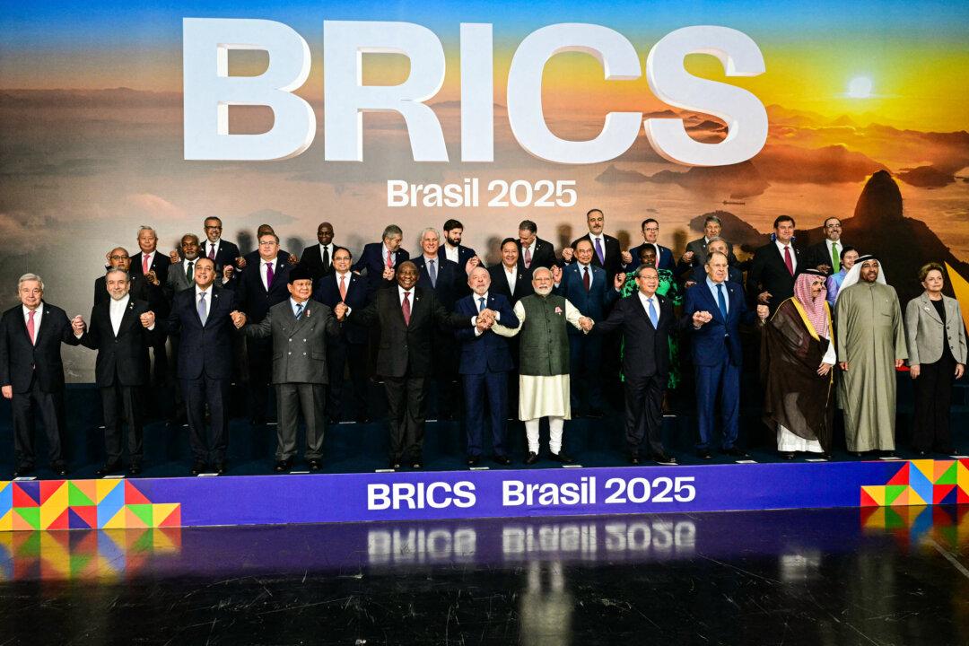 Heads of state and government from member, partner, and observer countries pose for a family photo during the BRICS summit in Rio de Janeiro, Brazil, on July 7, 2025. The China- and Russia-led bloc, seen as a counterweight to U.S.-aligned democracies, may play a key role in the growing currency rivalry between the Chinese yuan and the U.S. dollar. (Pablo Porciuncula/AFP via Getty Images)