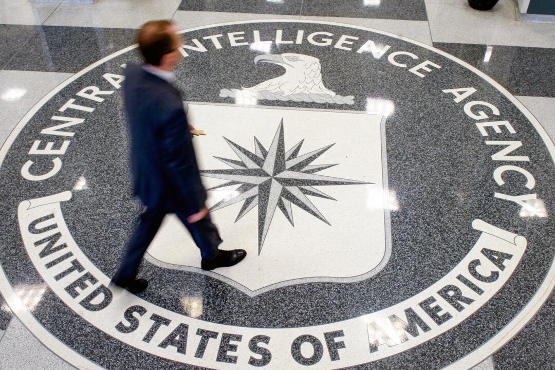 A man walks across the CIA seal in the lobby of the agency headquarters in Langley, Va., on Aug. 14, 2008. (Saul Loeb/AFP via Getty Images)