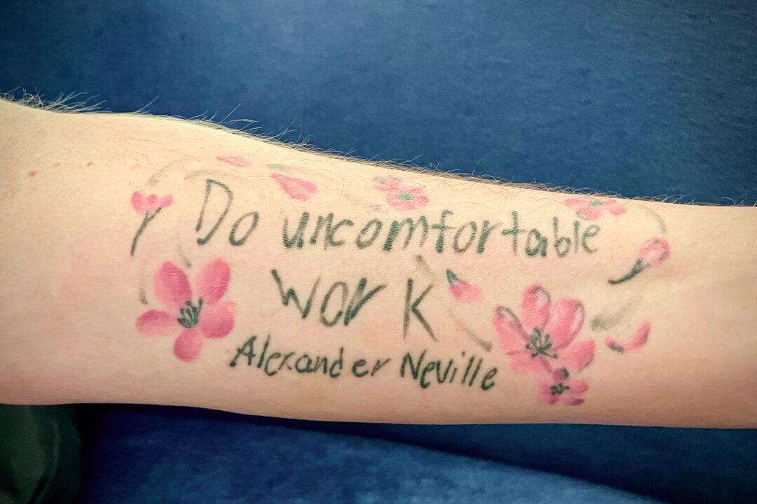 Amy Neville displays a tattoo on her left forearm reading “do uncomfortable work” in her late son Alexander’s handwriting, on the five-year anniversary of his death from fentanyl, in Washington on June 23, 2025. (Janice Hisle/The Epoch Times)